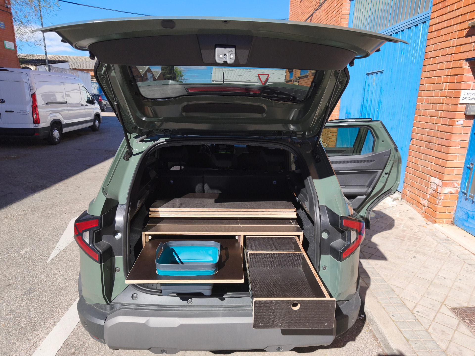 Dacia Duster camper box with dual-access storage chest and removable outdoor table