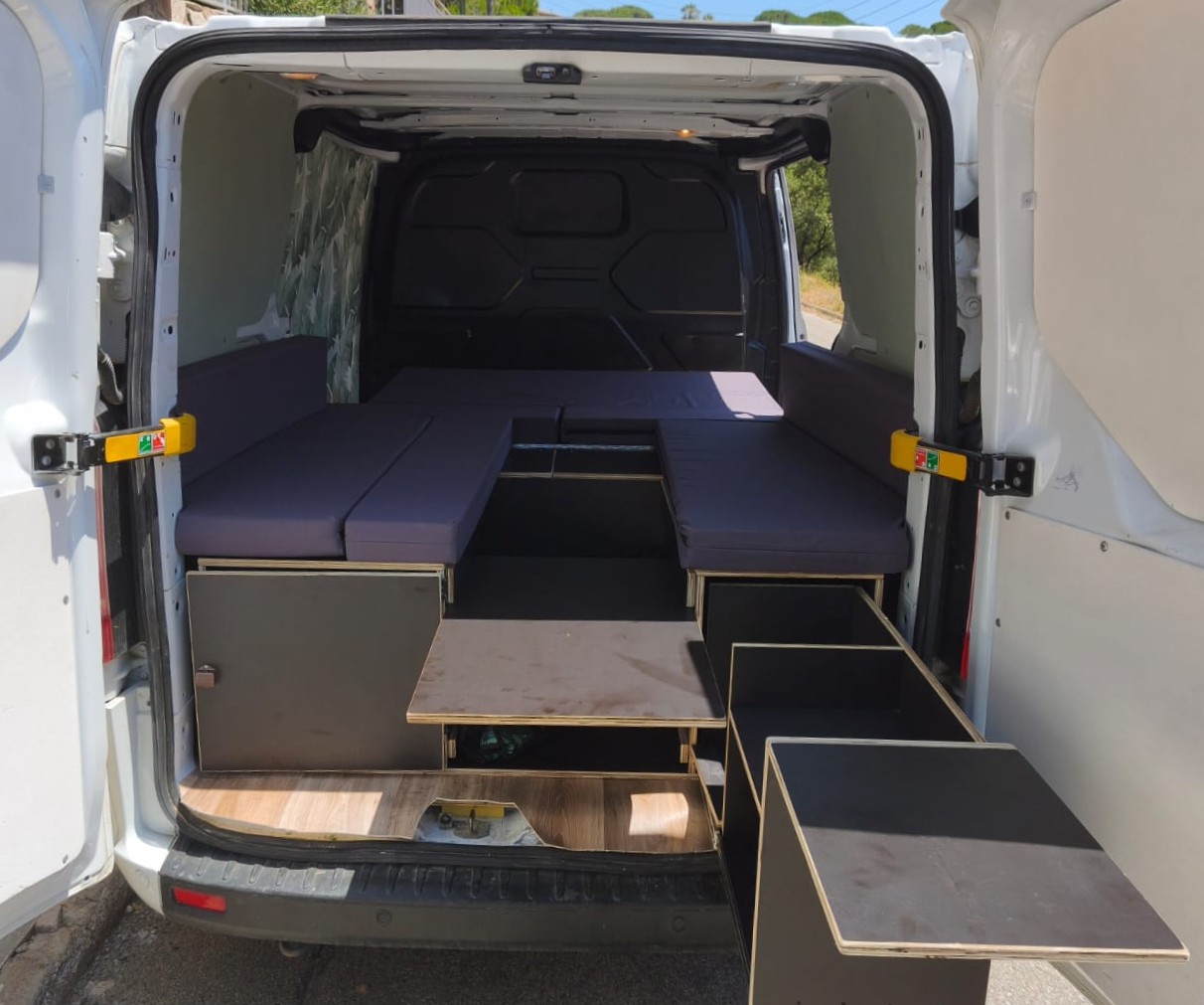 Multi-height table inside a Ford Tourneo Custom camper conversion for dining and lounge use